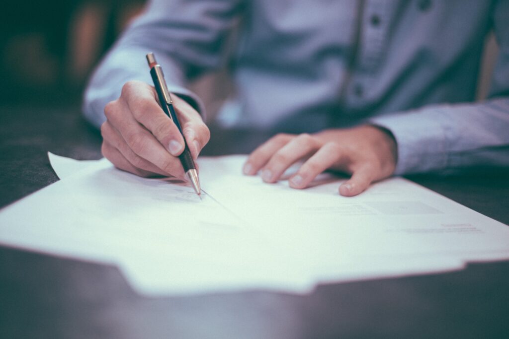 Person writing a document