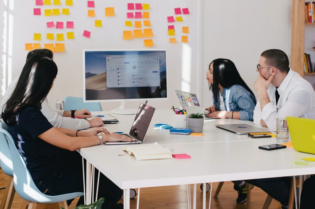 People observing board with sticky notes