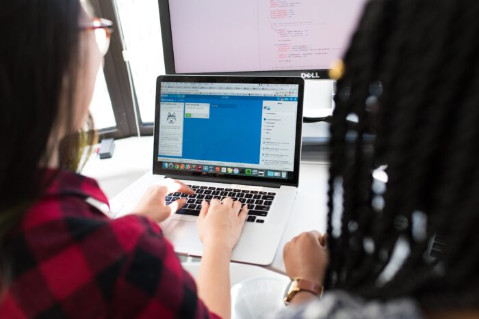 Two people using a computer