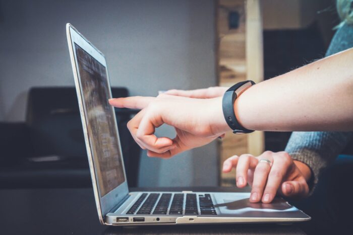 Photo of person pointing to a computer screen for a Kambu blog article about a Clutch review