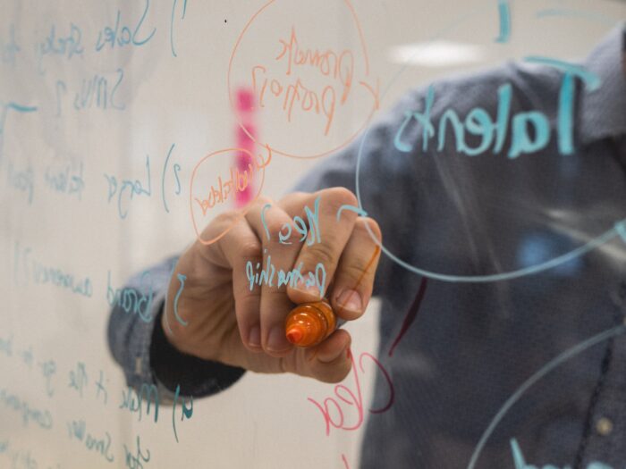 Photo of a person writing on glass for a Kambu blog article